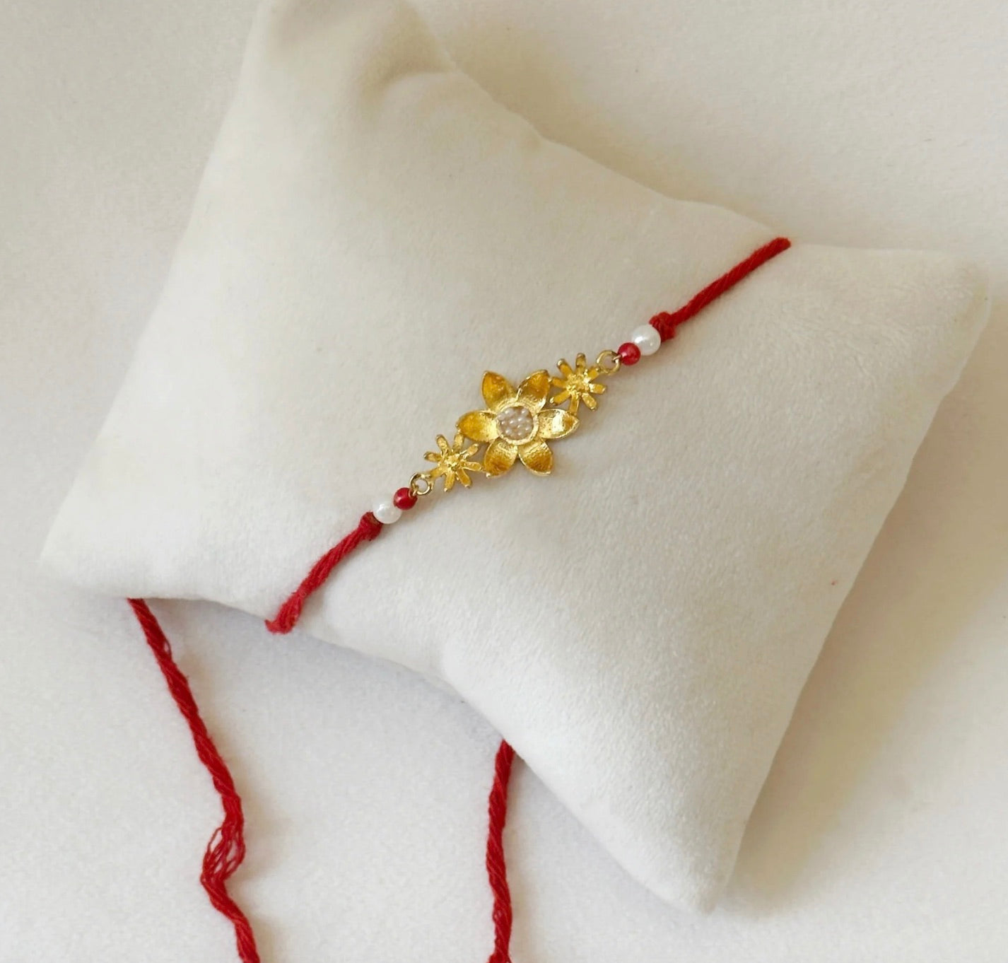 BLOOMING RAKHI GOLD AND RED