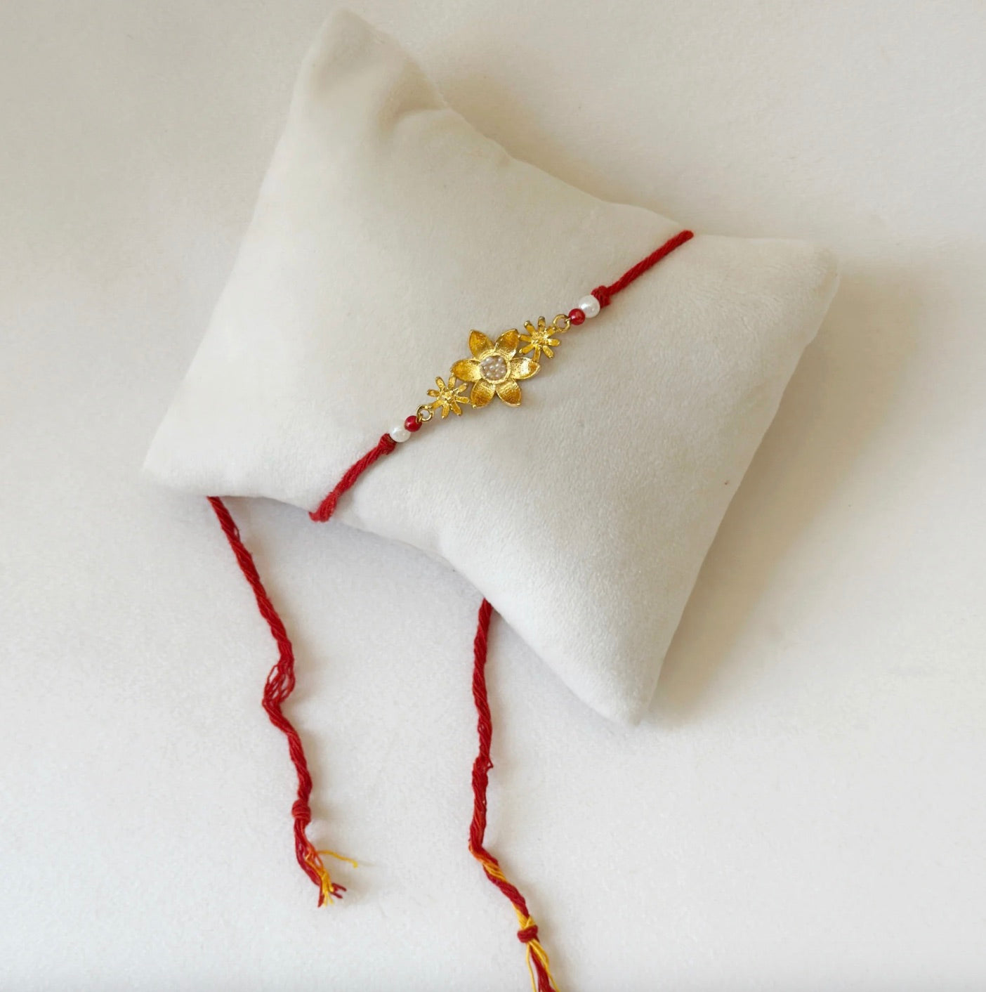 BLOOMING RAKHI GOLD AND RED