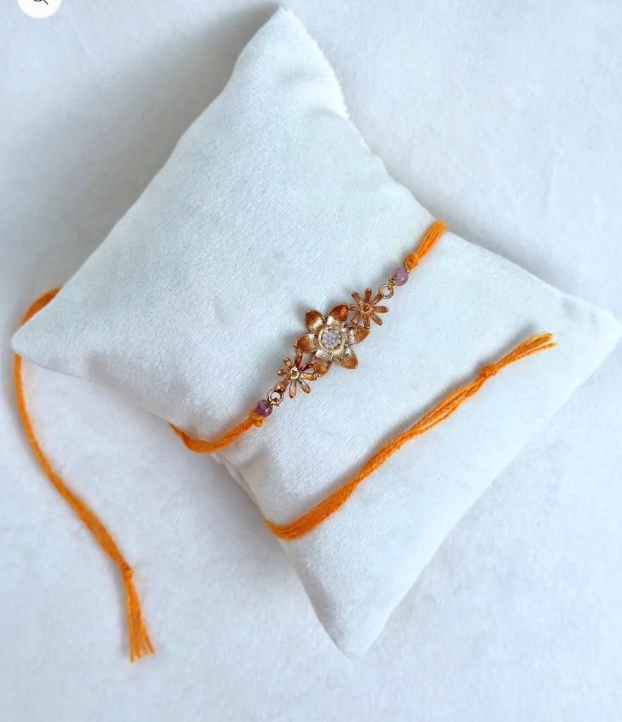 BLOOMING RAKHI ROSE GOLD AND SAFFRON
