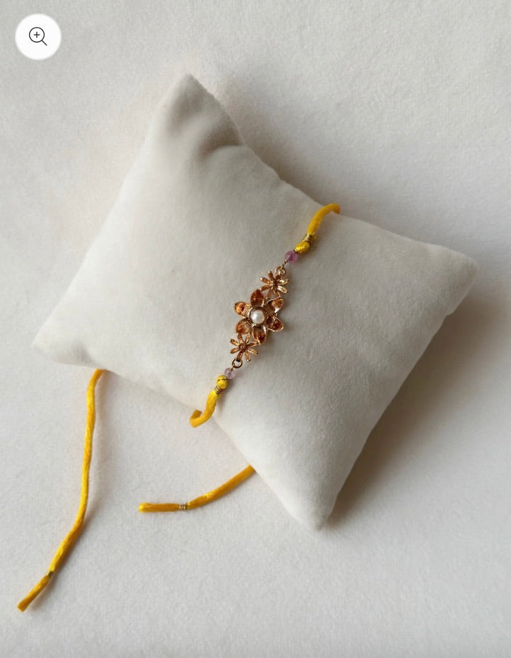 BLOOMING RAKHI ROSE GOLD AND SAFFRON