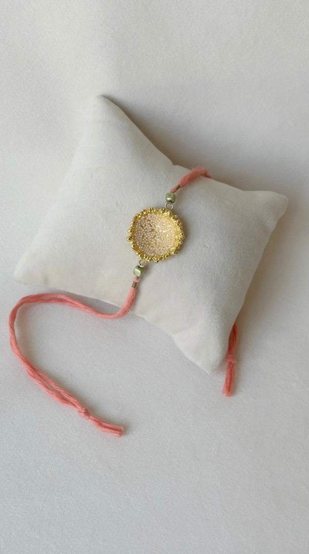 SURYA RAKHI GOLD AND PINK