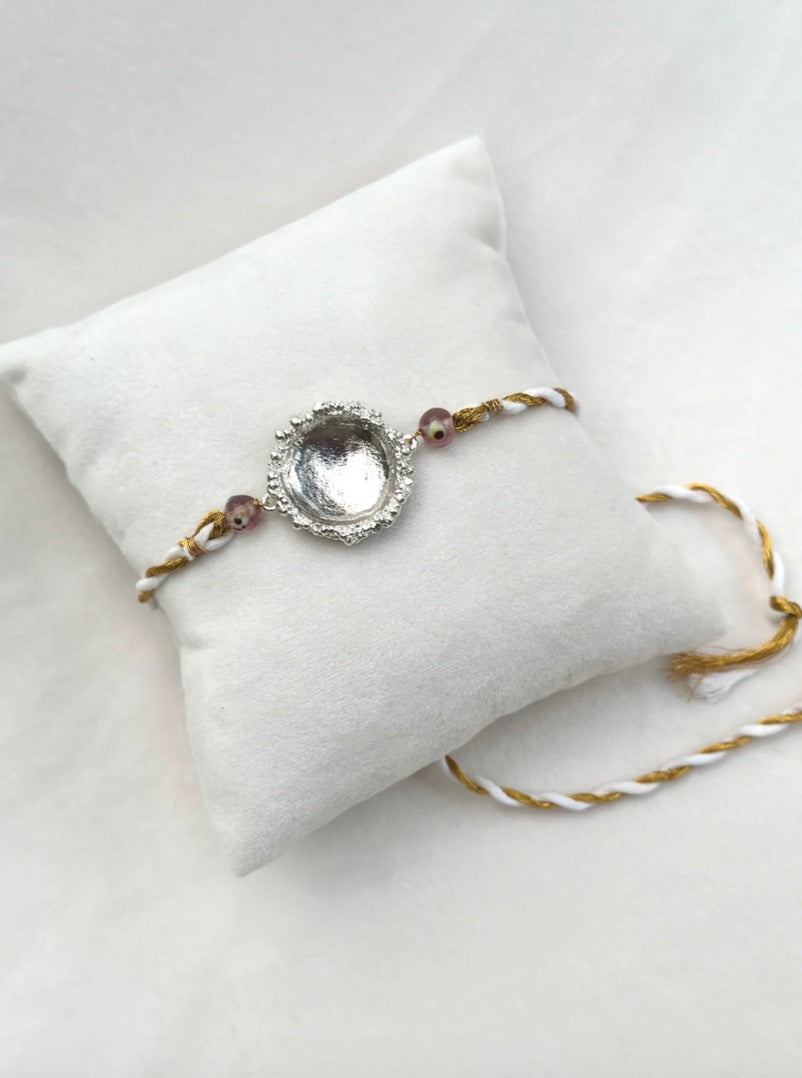 SURYA RAKHI SILVER AND WHITE GOLD