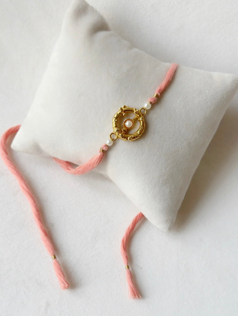 MUDRA STONE RAKHI GOLD AND PINK